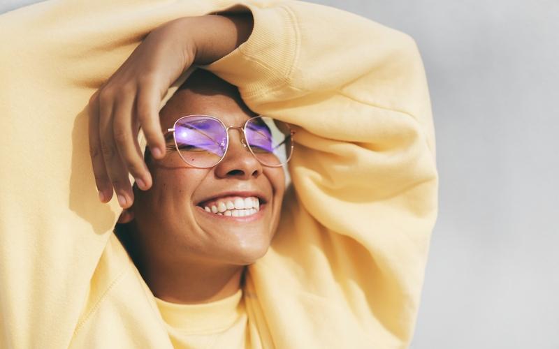 Person with arms overhead smiling